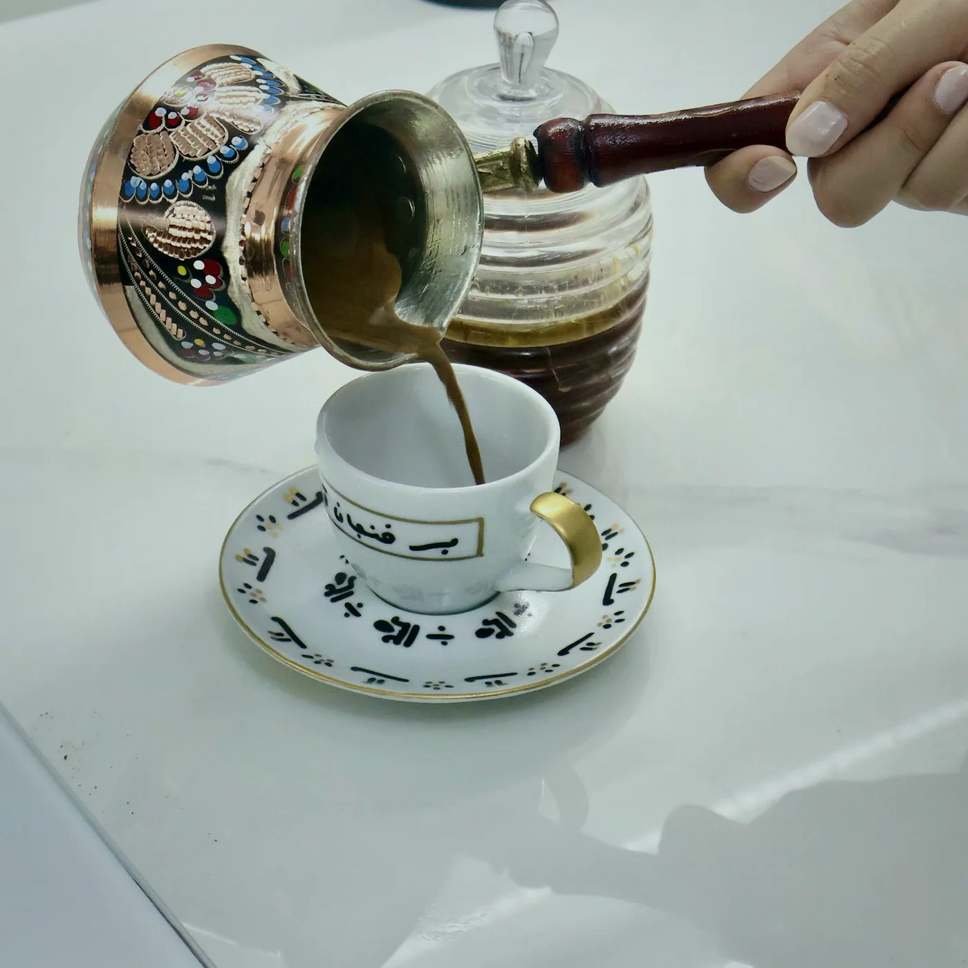 A pot of tea and two cups on the counter